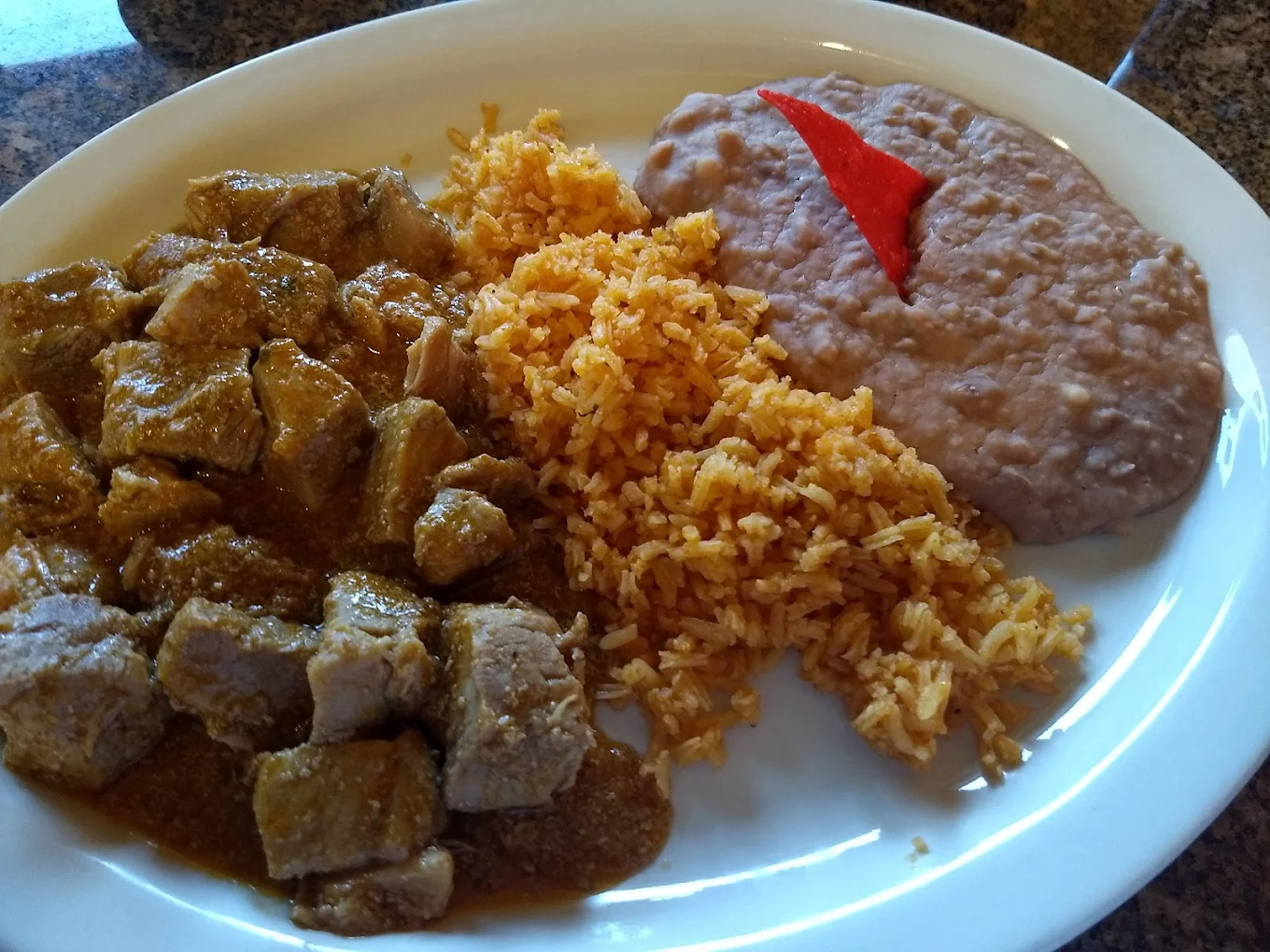 Carne Guisada Plate - Tender beef stewed in a rich, flavorful gravy.