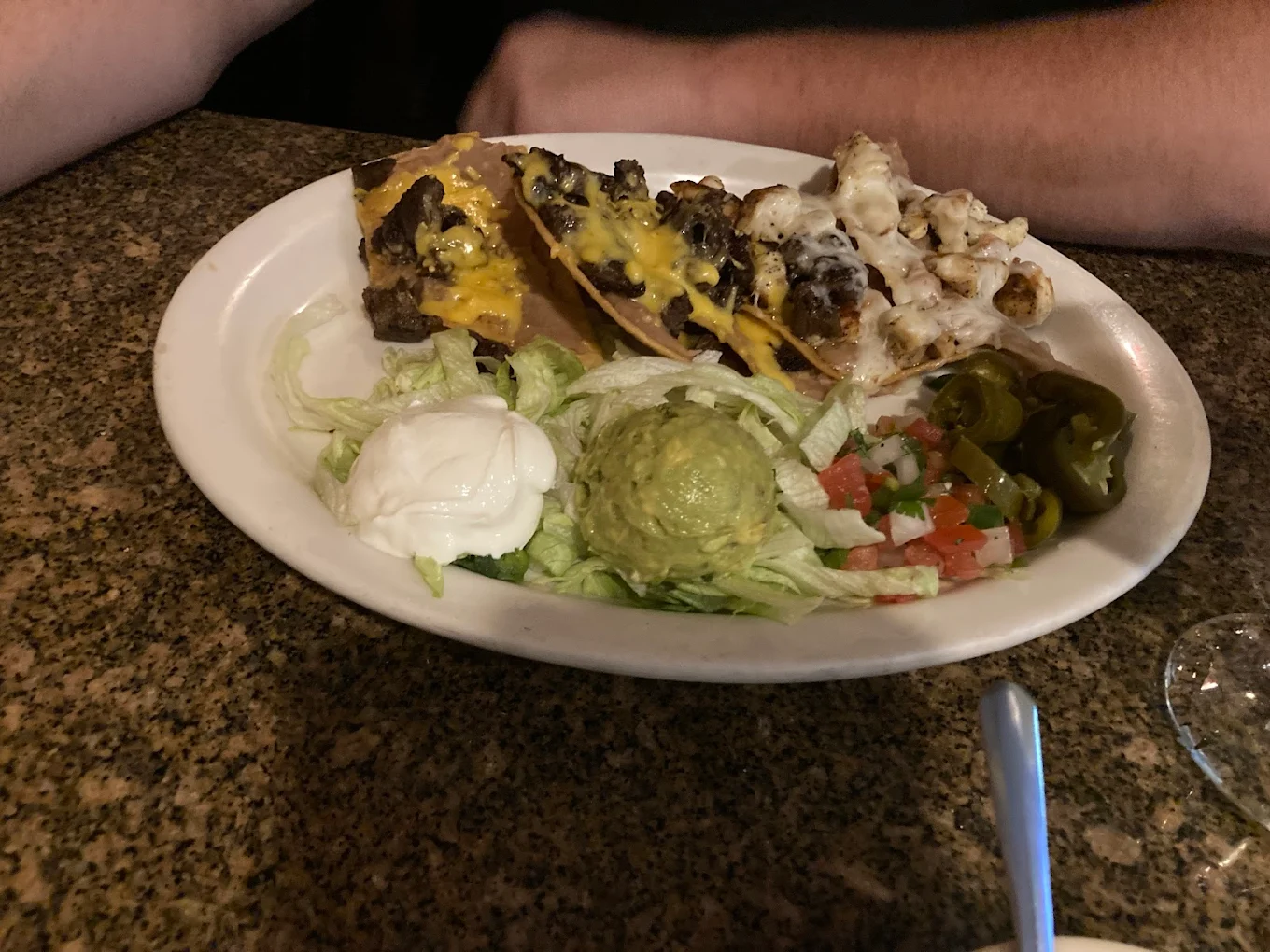 Fajita Nachos - Crispy tortilla chips topped with grilled fajita meat, melted cheese, and fresh toppings