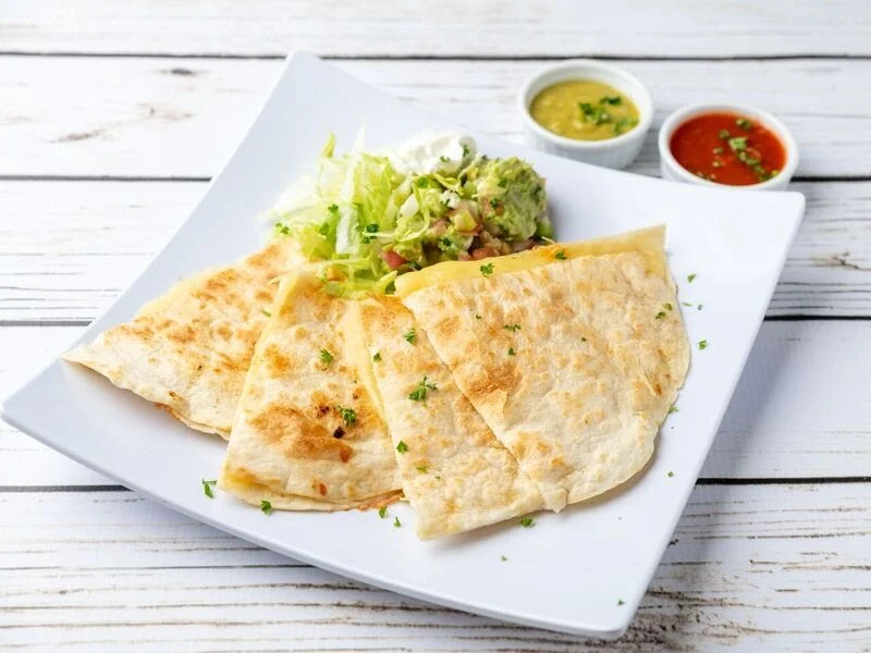 Cheese Quesadilla - Grilled flour tortilla filled with melted cheese, served with guacamole and sour cream